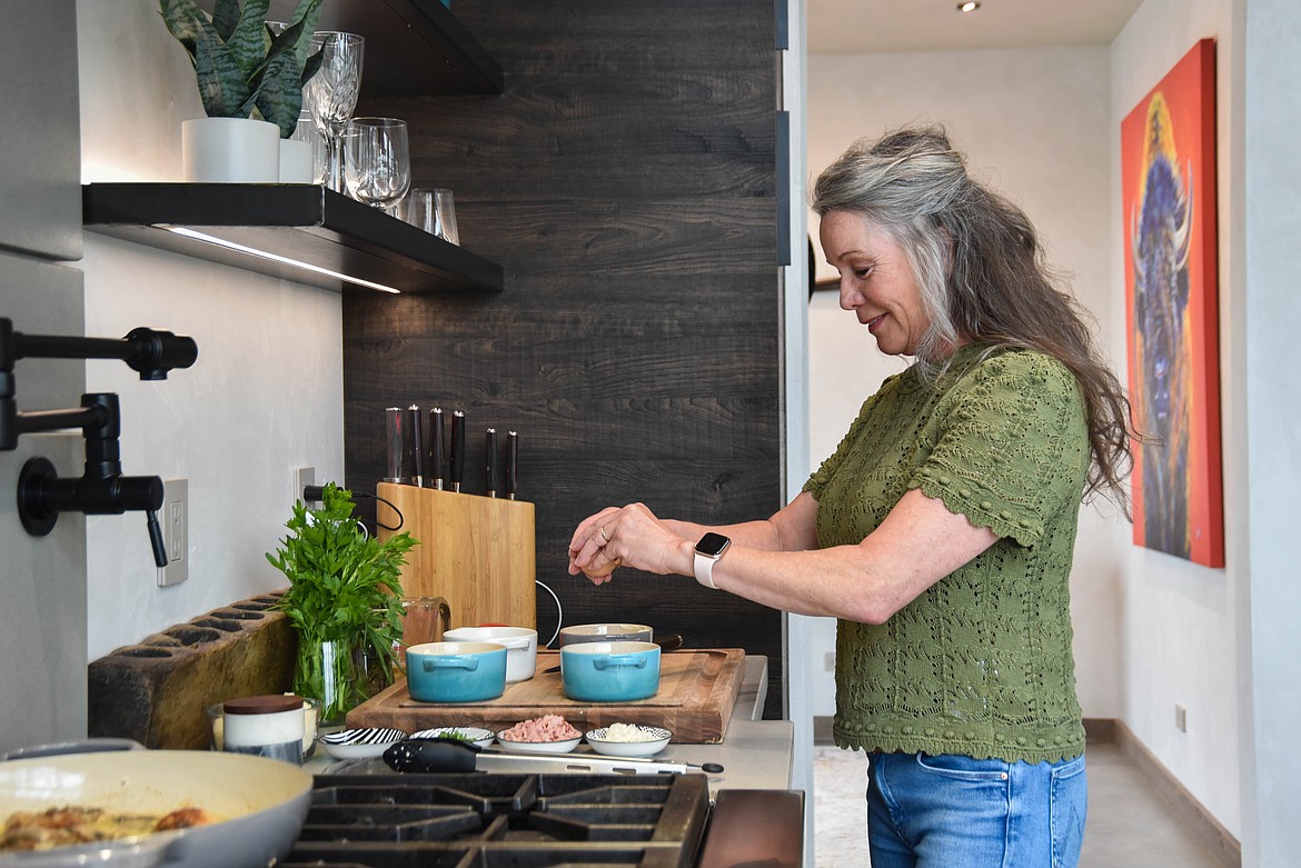Gina Simmonds, author of "How to Cook Like Mom," cooks in her kitchen in Whitefish on March 21, 2024. (Kate Heston/Daily Inter Lake)