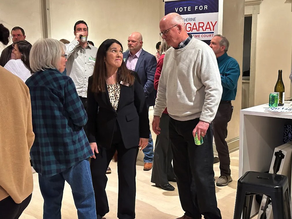 7th Judicial District Judge Katherine Bidegaray, center, speaks with supporters at a fundraiser for her Supreme Court candidacy in Missoula on Feb. 27, 2024. (Arren Kimbel-Sannit/Montana Free Press)