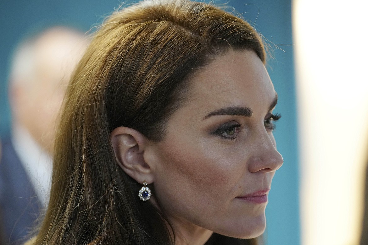 Britain's Kate, Princess of Wales, listens to staff as she and Prince William visit the Open Door Charity, a charity focused on supporting young adults across Merseyside with their mental health, using culture and creativity as the catalyst for change in Birkenhead, England, Jan. 12, 2023. (AP Photo/Jon Super, Pool, File)