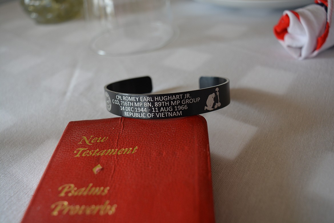 A bracelet commemorating Romey Earl Hughart Jr. was placed with symbolic items at the “fallen comrade table” during Joel Walker's Quilt of Valor ceremony.