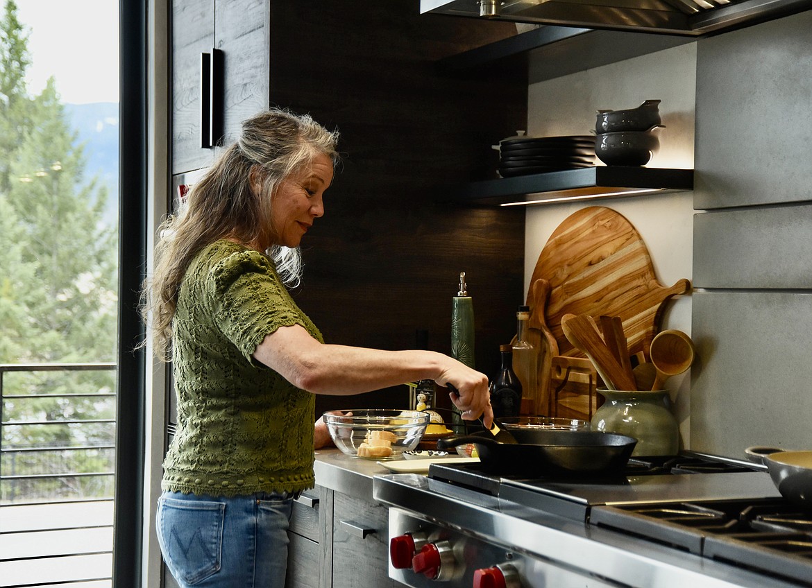 Gina Simmonds, author of "How to Cook Like Mom," cooks in her kitchen in Whitefish on March 21, 2024. (Kate Heston/Daily Inter Lake)