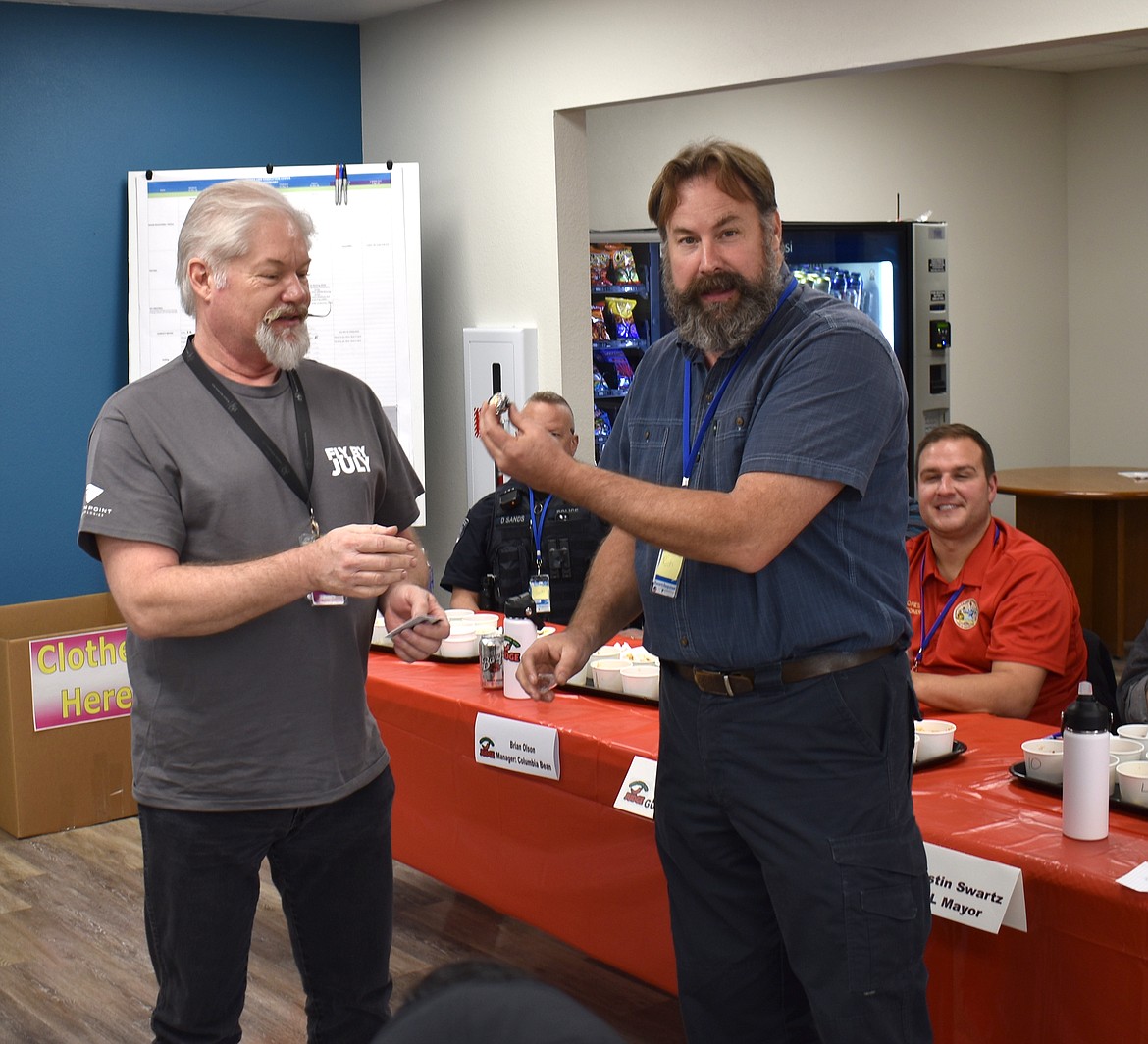 Moses Lake Airport Director Rich Mueller presents Greenpoint Principal Engineer – and Chili Master – Gary Neu with the first-place ring at Greenpoint’s chili cookoff Thursday.