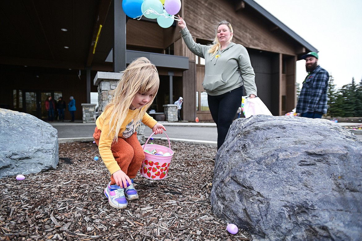 A child picks up eggs during an Inclusive Easter Egg Hunt for kids with low vision, sensory or wheelchair and walker accessibility needs hosted Healthy Beginnings Pediatric Therapy in Columbia Falls on Saturday, March 23. (Casey Kreider/Daily Inter Lake)
