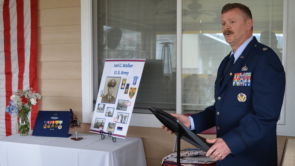 Joel Walker's son-in-law, Michael Hinz, retired USAF describes the meaning behind his father-in-law's medals and military honors during a Quilt of Valor presentation Friday at the Walker residence in Post Falls.