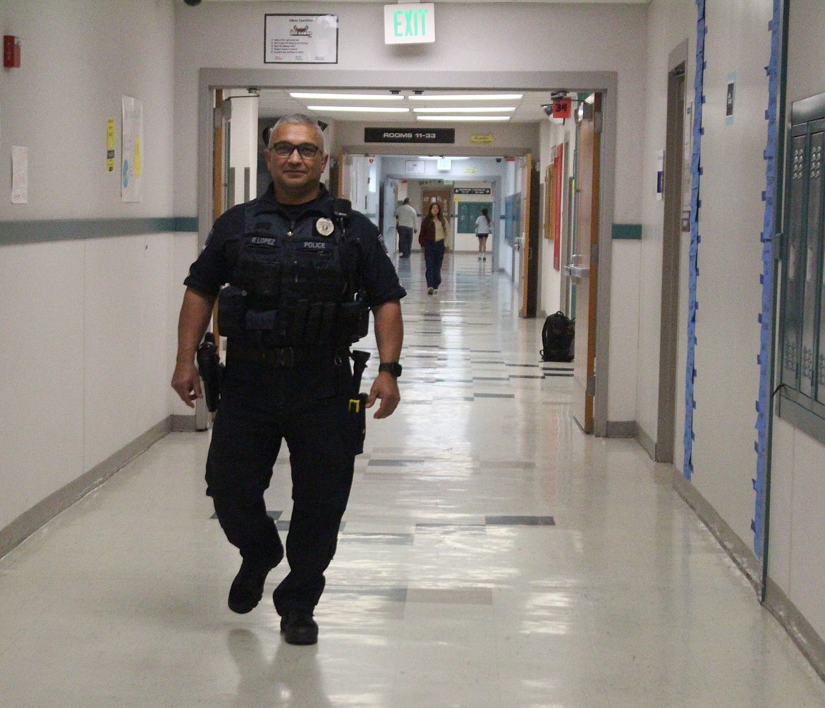 School Resource Officer Ray Lopez walks through the halls at Columbia Middle School. He said one of the most important parts of his job is fostering good relationships with the young people he encounters on the job.