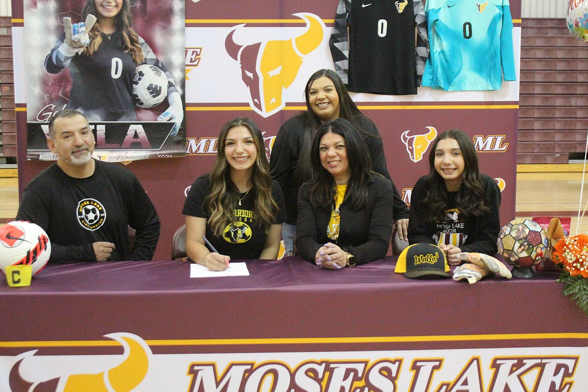 Gabi Vela, second from left, signs to play soccer at Walla Walla Community College in the company of her dad Rene Vela, left, mom Maria Vela, second from right, and sisters Ely Vela, right, and Mia Vela, back.