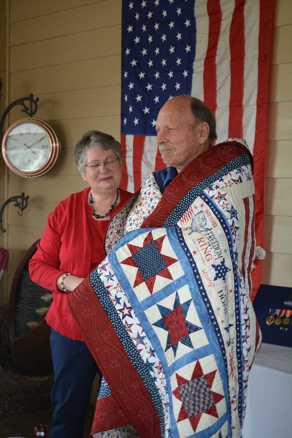 Giannine O’Connor holds back tears after presenting Joel Walker with his quilt. The Quilts of Valor ceremony Friday had many tearing up after hearing Joel Walker’s experiences in Vietnam and the story of close friend Romey Earl Hughart Jr., who was killed in action Aug. 11, 1966.