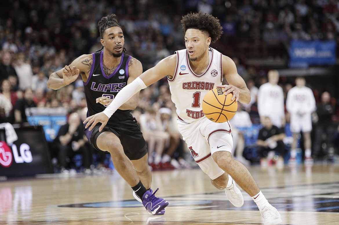YOUNG KWAK/Associated Press
Alabama guard Mark Sears (1) drives while pressured by Grand Canyon guard Collin Moore during the first half of a second-round game in the NCAA Tournament on Sunday at the Spokane Arena.