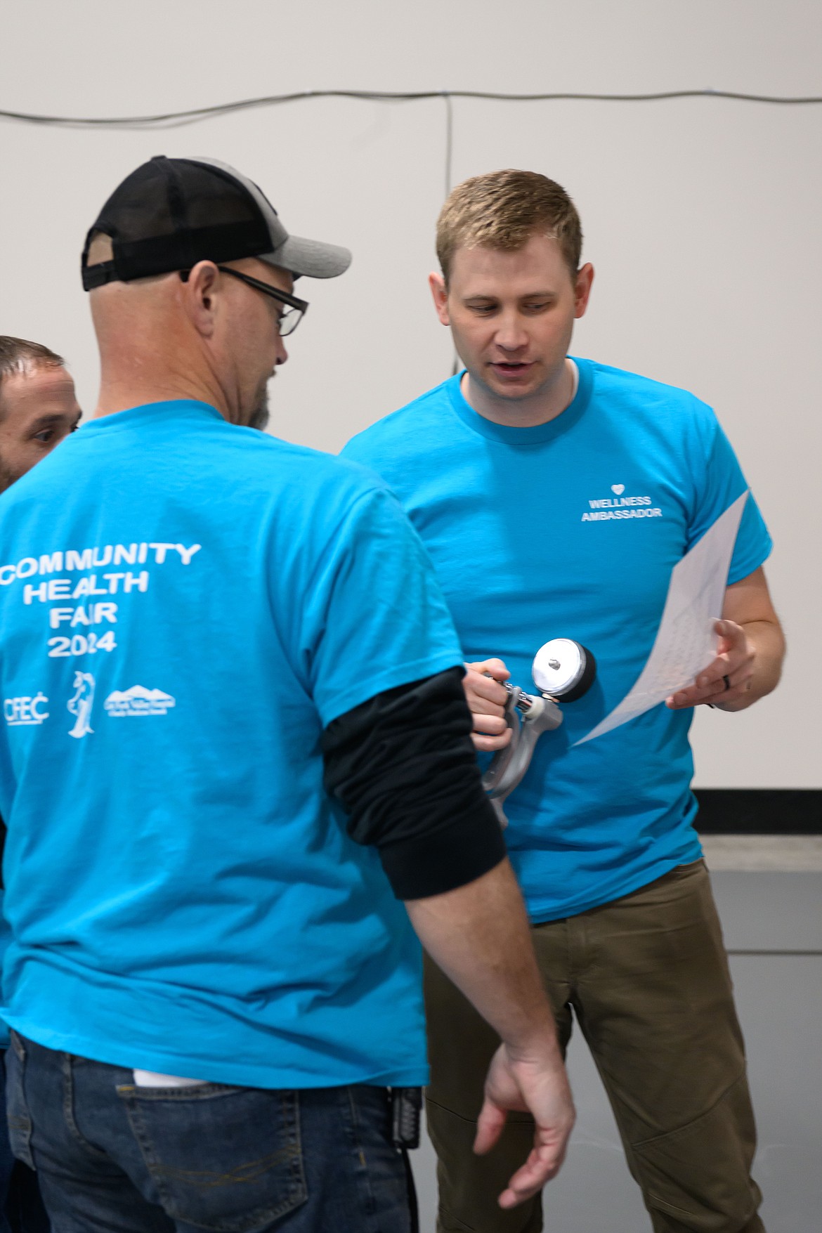 Physical therapist Brandon Fowler demonstrates techniques used for patient rehabilitation at the health fair in Plains. (Tracy Scott/Valley Press)