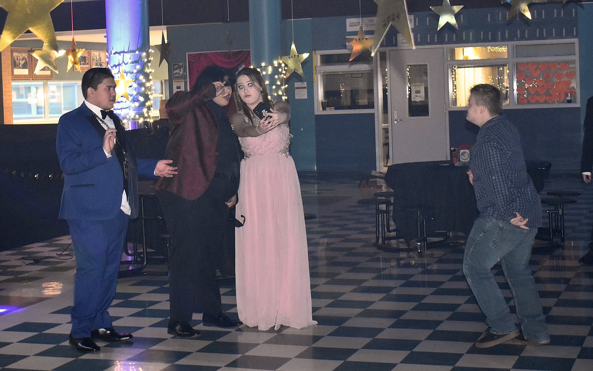 Yasmin Luna Chavez, left, and a fellow PALS Club member take a selfie at the PALS Prom Friday, flanked by Bryan Luna Chavez, left, and Ethan Farmer.
