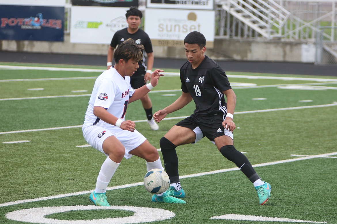 Royal junior Alexis Gonzalez (19) defends against a College Place player during Saturday’s match.