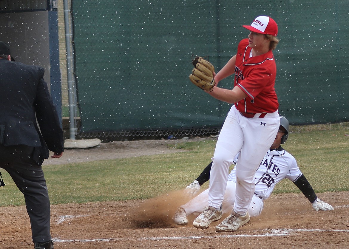 Polson's Zak Muzquiz (20) slides around a late tag at home plate during Polson's 20-1 win over T Falls-Noxon in a high school baseball game this past Saturday. (Photo by Bob Gunderson)