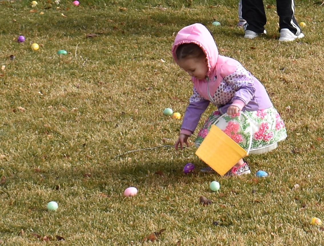 Blakely Gayle Van Dyke, then 2, picks up an egg at the George Easter egg hunt last year. Children will be looking for eggs in George at 9 a.m. Saturday.