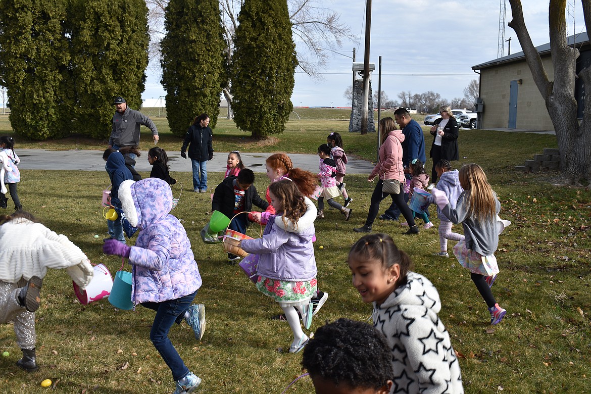 Five- and 6-year-olds hop on one foot in search of eggs at the George Easter egg hunt in 2023.