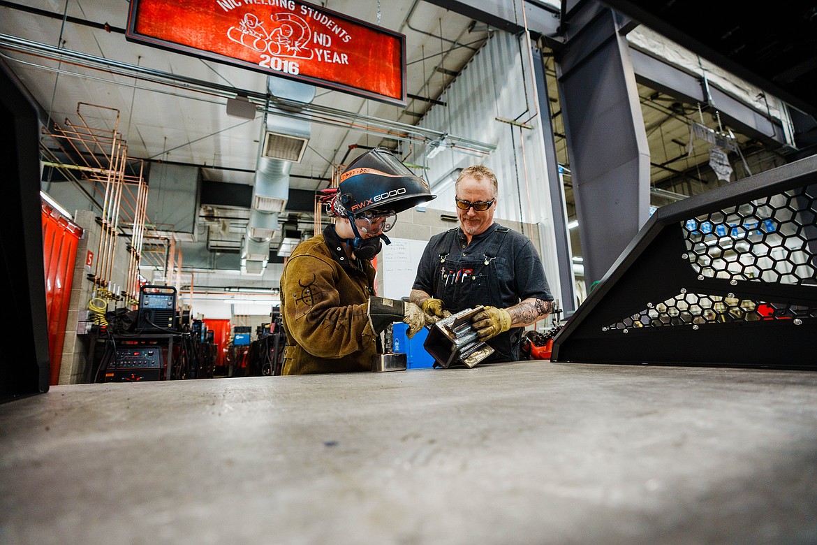 Former NIC student Ali Barnett, left, talks with NIC Welding Instructor Tim Straw in a welding lab at NIC’s Parker Technical Education Center