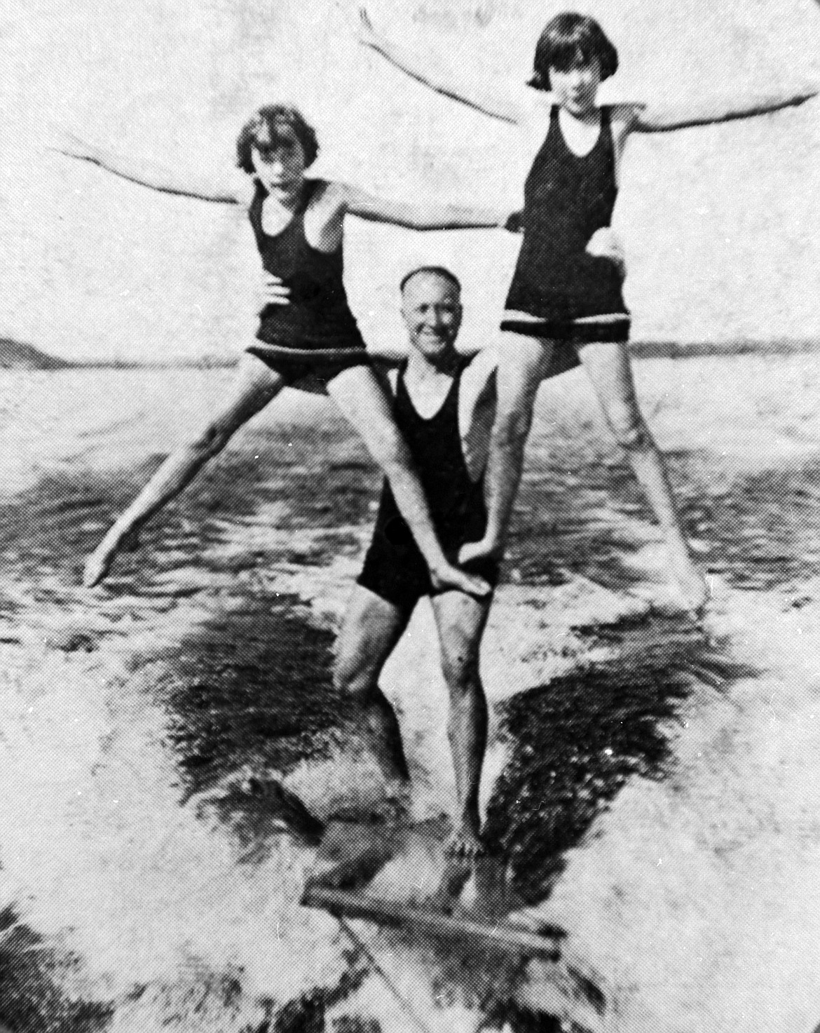 Jack Finney performs a water stunt with daughters Harriett and Mary.