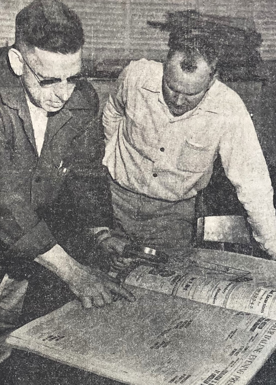 Herb Robinson, left, and George Evjen, of Seattle, pore over 1920s editions of the Coeur d’Alene Press.
