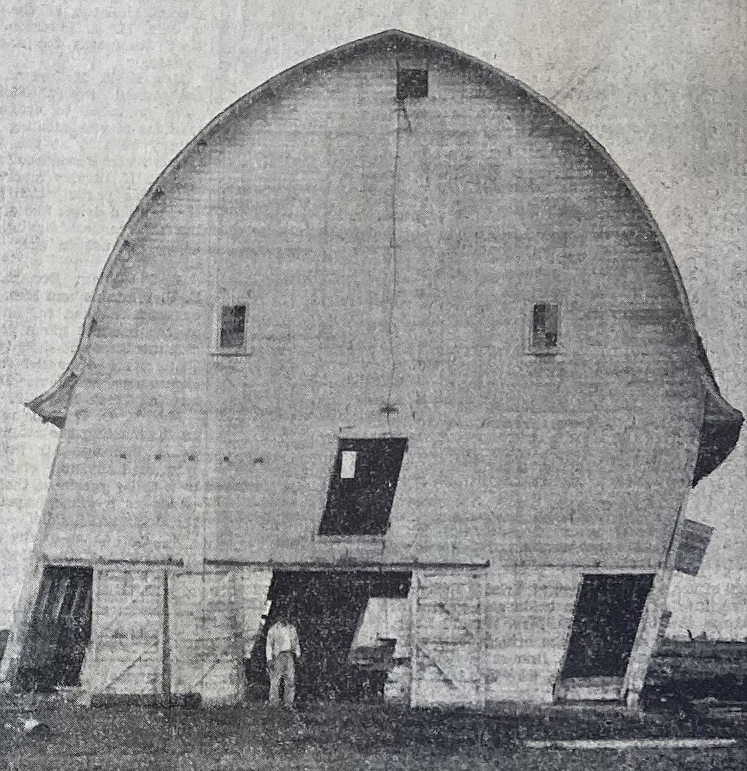 Mannie Schneidmiller stands in the door of his leaning Post Falls barn.