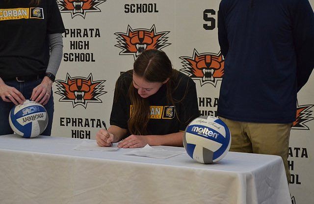 Addison Mills signs on with Corban University last week during a signing ceremony at Ephrata High School. Mills said her competitive nature is part of what led to the opportunity to play college volleyball.