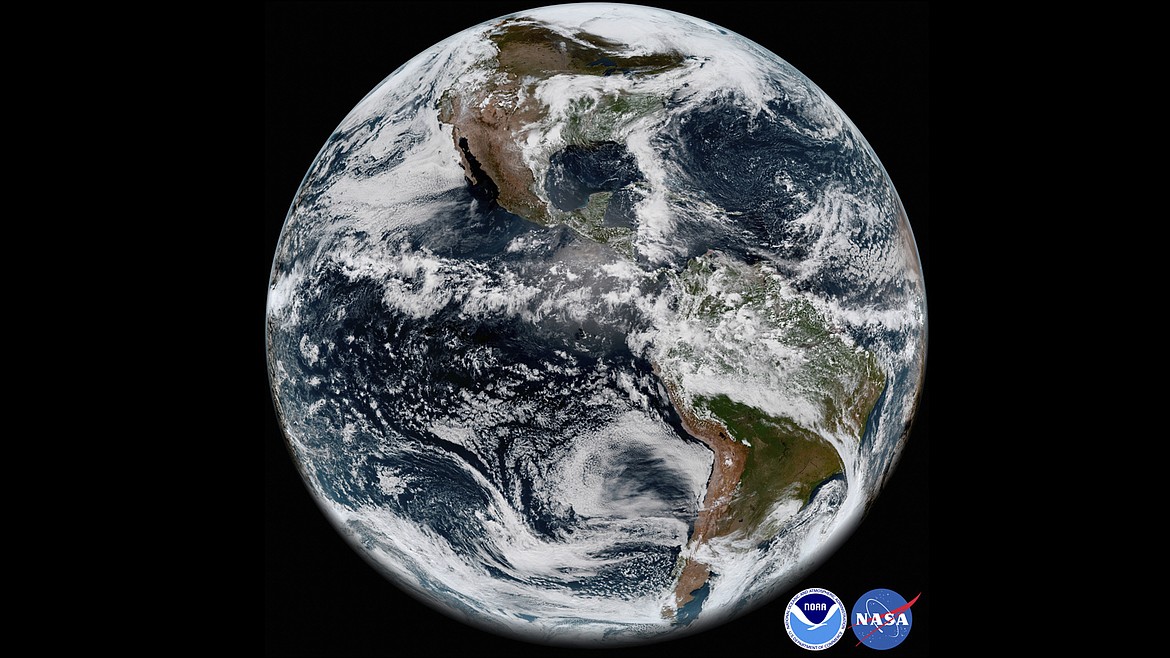 This image provided by NOAA/NASA In This May 31, 2018 satellite image shows the Earth's western hemisphere at 12:00 p.m. EDT on May 20, 2018, made by the new GOES-17 satellite, using the Advanced Baseline Imager (ABI) instrument. For the first time in history, world timekeepers may have to consider subtracting a second from our clocks in a few years because the planet is rotating a tad faster. (NOAA/NASA via AP, File)