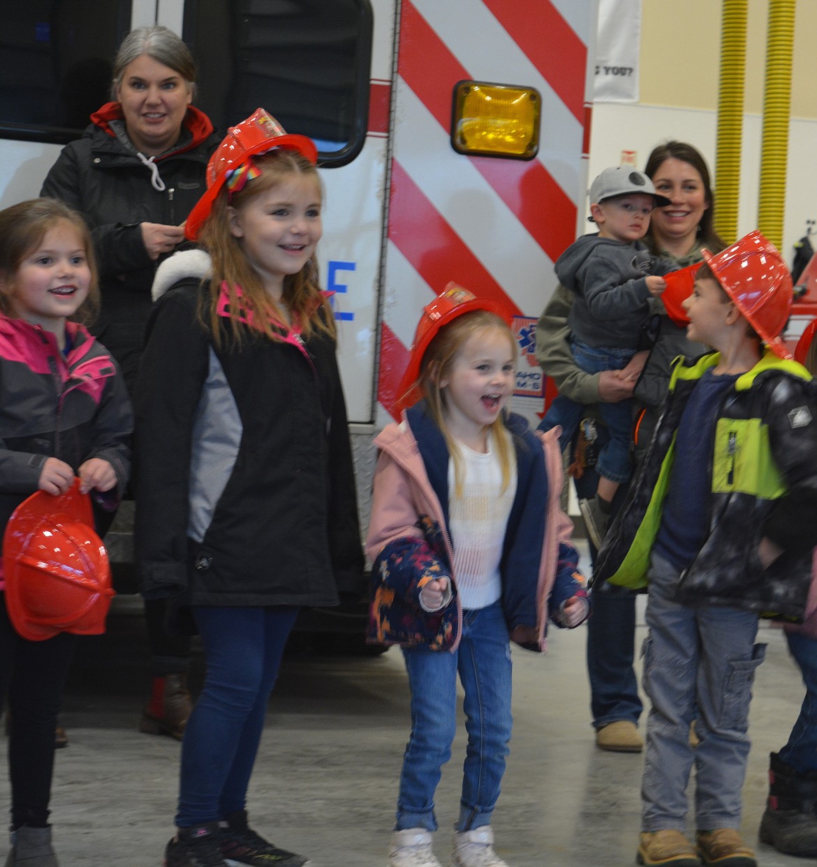 Kindergarteners Layla Lister, Macie Maravilla, Emma Bennett and Conor Clark cheer on Cooper Welk as he puts on his gear as quickly as he can.