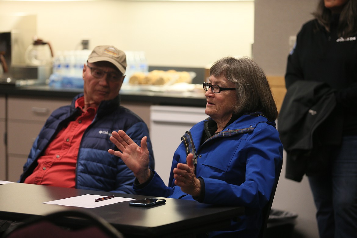 Kim Brown asks a question Wednesday evening about preserving artifacts from the 118-year-old Post Falls Dam North Channel as she and husband Lew Brown attend an open house on Avista's rehabilitation project of the facility, which will begin this spring.