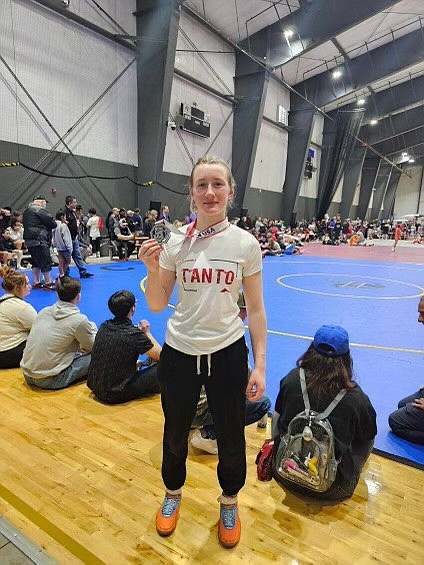 Shelby Garten shows off the medal she won in Freestyle at USAW Northwest Regionals. Garten's second-place finish qualifies her for USAW Freestyle/Greco Nationals in Fargo this summer.