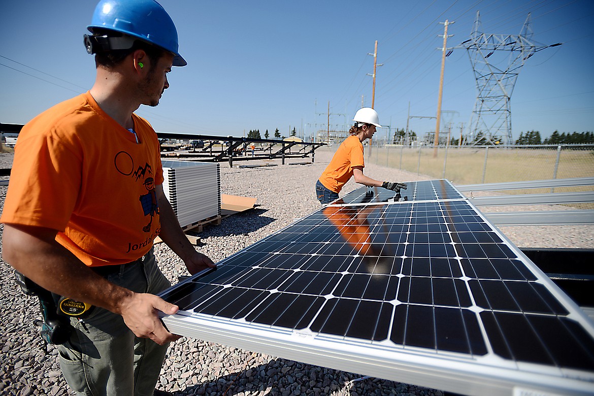 Workers install a solar panel on Whitefish Stage Road north of Kalispell in August 2015 as part of Flathead Electric Co-op's community solar project. (Daily Inter Lake FILE)