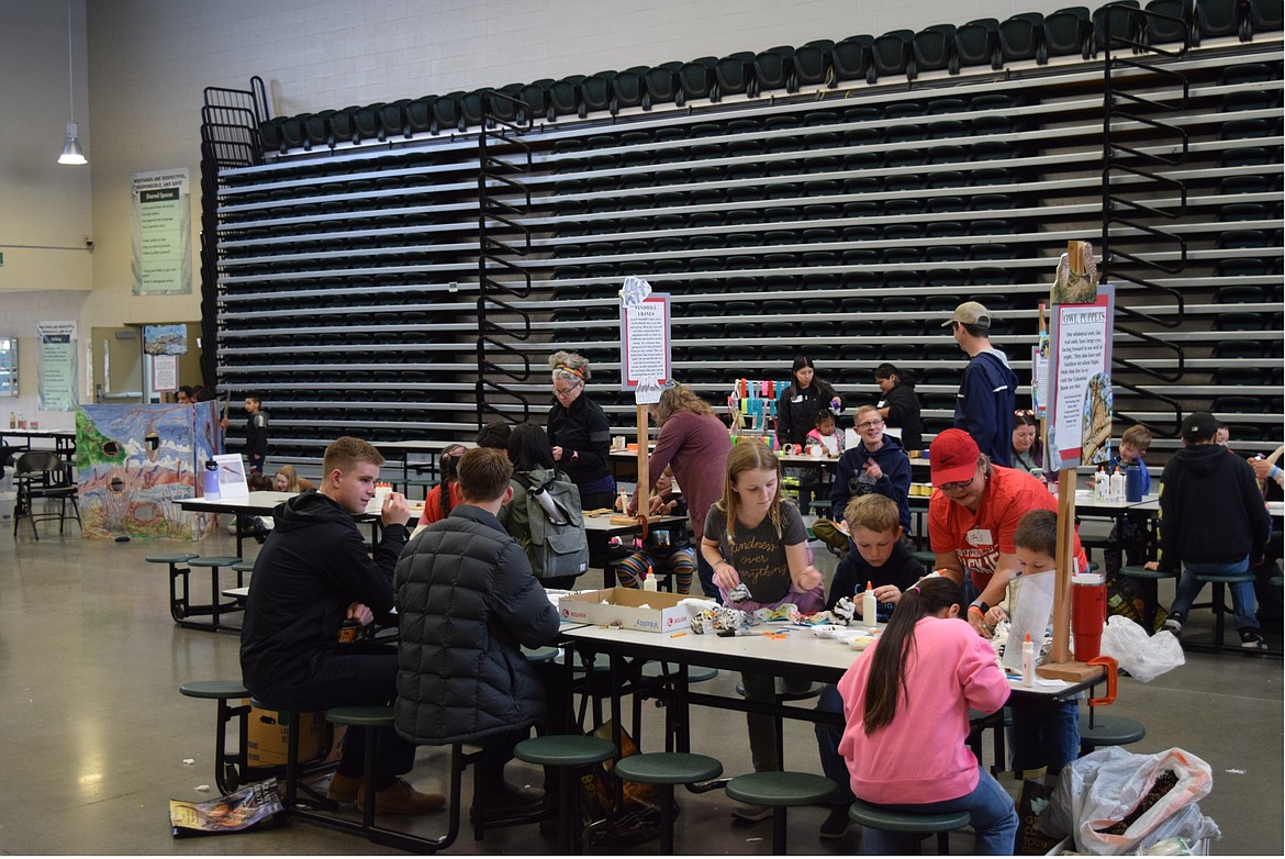 Parents and children do crafts and activities in the McFarland Middle School cafeteria March 23 at the Othello Sandhill Crane Festival.