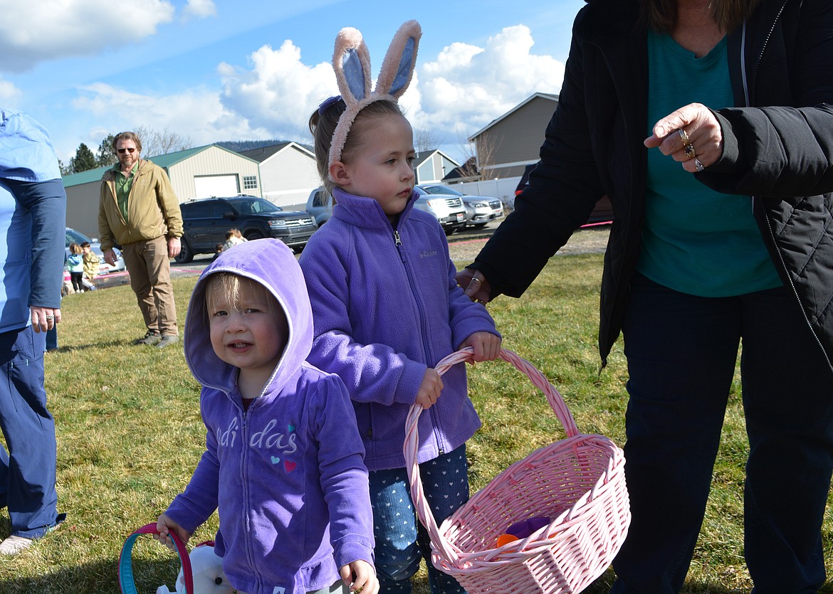 Charlie Maloney, 2 and Elsie Maloney, 4 rest after the youngest group went on an egg hunt at the Hayden Clubhouse.