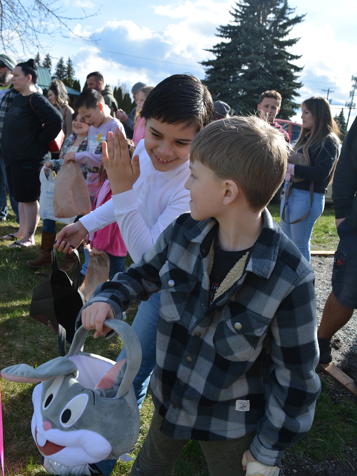 Jesse Tafoya, 9, of Coeur d'Alene whispers his strategy to Maddox McLain, 8, of Hayden before the Easter Eggstravaganza at the Clubhouse in Hayden.