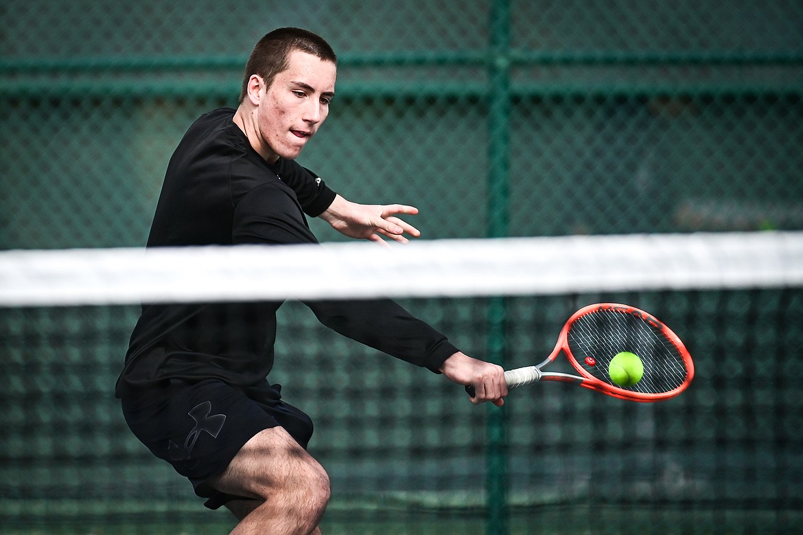 Flathead's Holden Askvig hits a backhand return in a boys singles match against Helena's Rhys Anderson-Foster at FVCC on Saturday, March 30. (Casey Kreider/Daily Inter Lake)