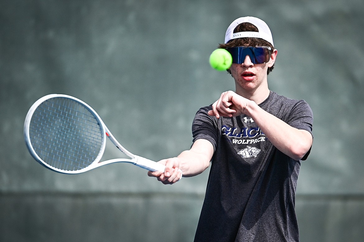 Glacier's Robby Thornburg hits a return in a boys singles match against Helena Capital's Caden McCullough at FVCC on Saturday, March 30. (Casey Kreider/Daily Inter Lake)