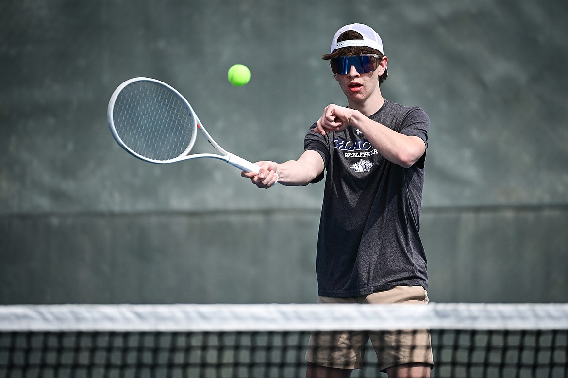 Glacier's Robby Thornburg hits a return in a boys singles match against Helena Capital's Caden McCullough at FVCC on Saturday, March 30. (Casey Kreider/Daily Inter Lake)