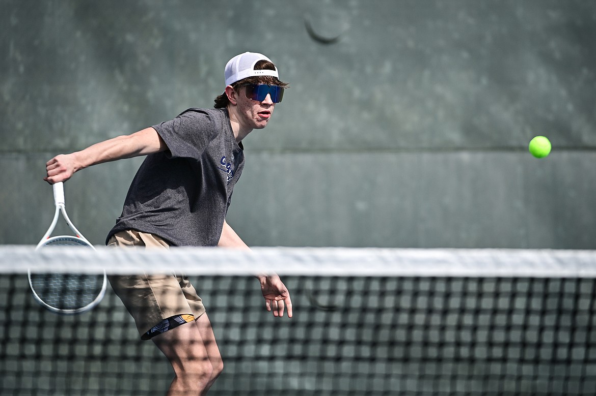 Glacier's Robby Thornburg hits a backhand return in a boys singles match against Helena Capital's Caden McCullough at FVCC on Saturday, March 30. (Casey Kreider/Daily Inter Lake)