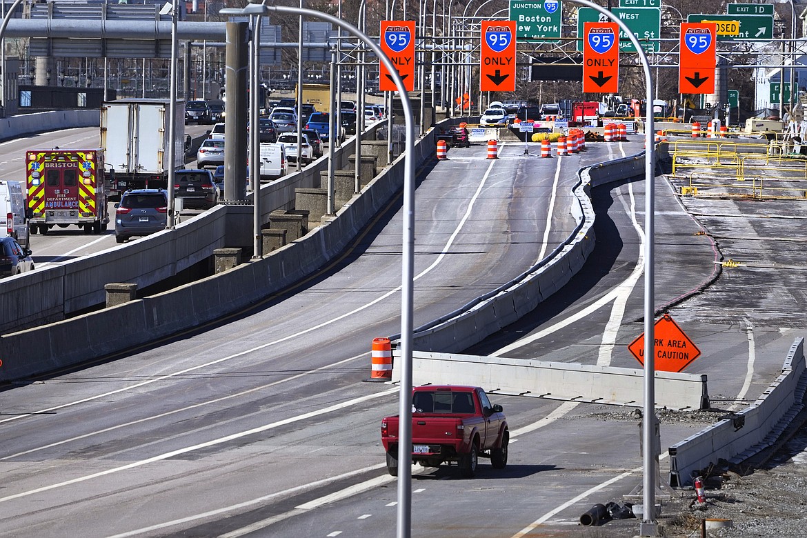 Diverted traffic, including an ambulance on a call, passes a closed portion of the Washington Bridge, Friday, March 8, 2024, in East Providence, R.I. The closure of a section of the bridge, and onramps, due to failure of some bridge components, has caused a significant loss to local businesses. (AP Photo/Charles Krupa)