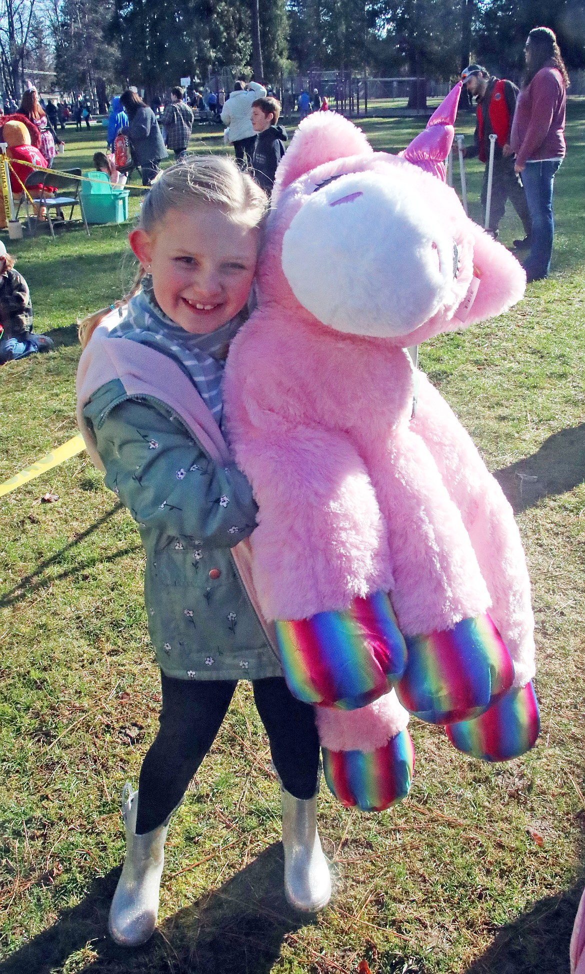 McCall Carey holds the large stuffed unicorn she received after finding a egg with a special ticket tucked inside for a prize. Several hundred local youth turned out for the annual Easter egg hunt, which has been held by the Sandpoint Lions for the past 70-plus years.