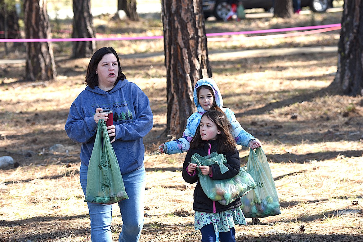 SUCCESSFUL EGG hunters bring in their collection Saturday morning at the annual Easter egg hunt Saturday morning at Libby Christian Church. (Scott Shindledecker/The Western News)