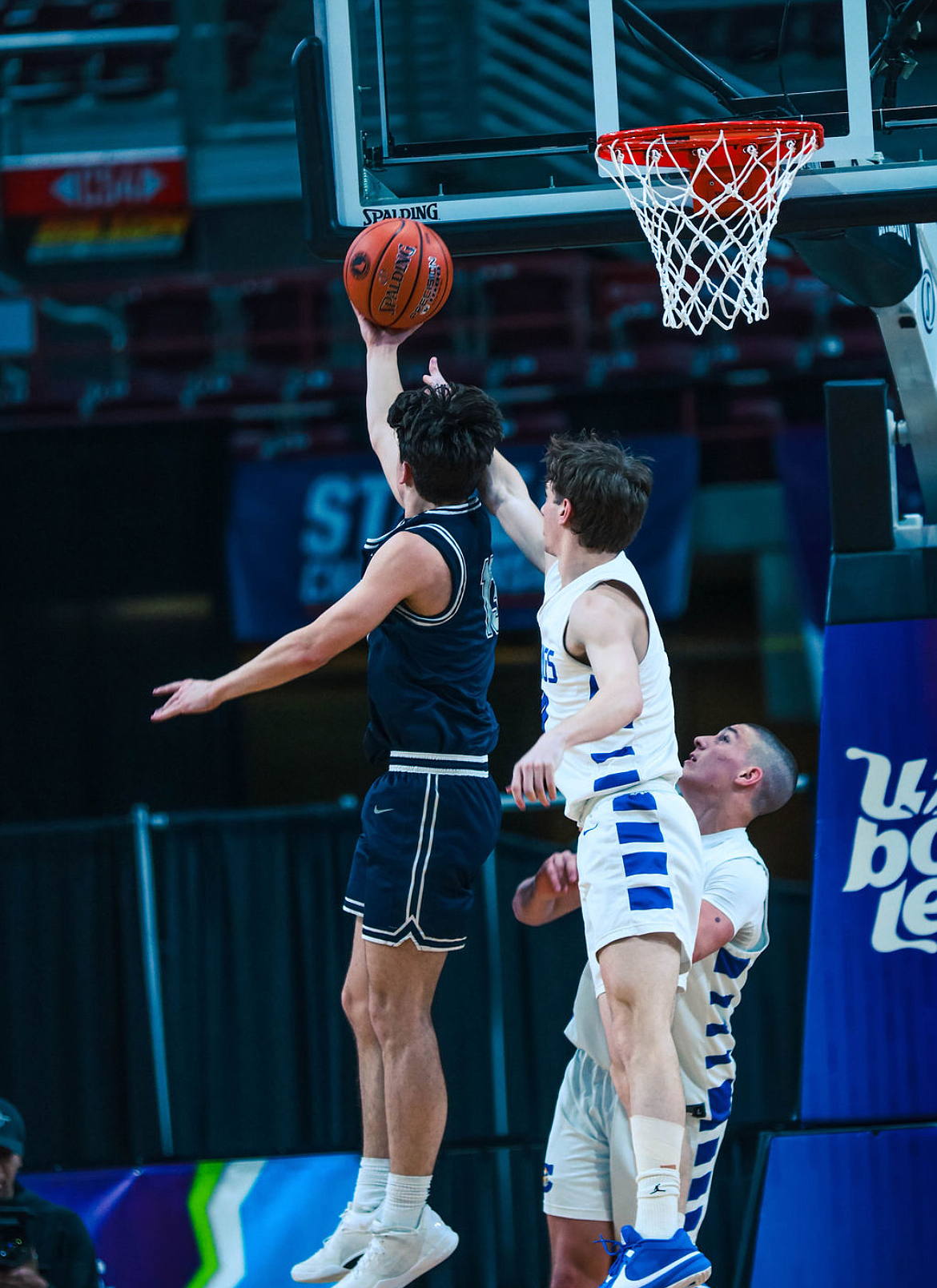 CADEN SIMMONS/Special to The Press
Caden Simmons, a freshman at Lake City High "who is discovering his passion with photography," shared some photos from the recent state high school boys basketball tournament. In this shot, Braydn Arrieta of Lake City shoots a layup as Gunner Larson of Coeur d'Alene challenges and teammate Kai Wheeler looks on.