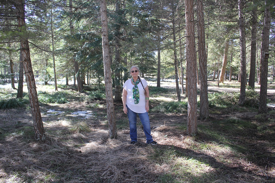 Christie Carriles stands in front of her house in DeBorgia where her homeowners insurance said tree mitigation must be performed before they can continue to issue a policy. (Monte Turner/Mineral Independent)