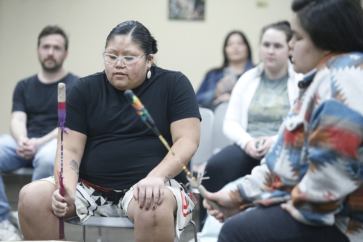 Cheyenne Meschell drums alongside fellow members of the Rose Creek Singers on Monday.