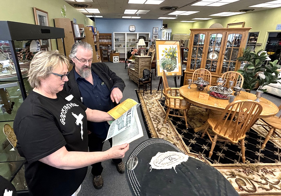 Store Manager Nancy Cafferty and Pastor Tim Remington look over an item for sale at the Good Samaritan Thrift Store on Monday.