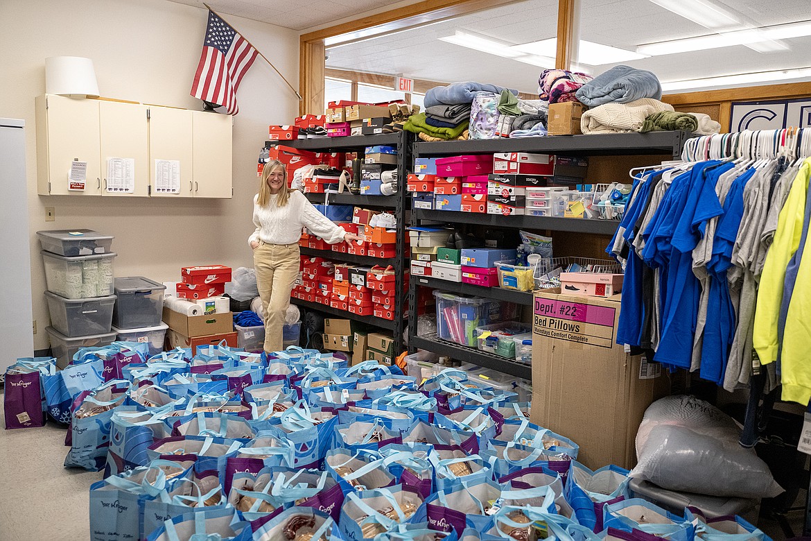 Tamara Sundberg shows off Columbia Falls High School’s clothes closet, being combined with its food pantry. Before her, bags of food sit ready to be sent home with students for Spring Break.