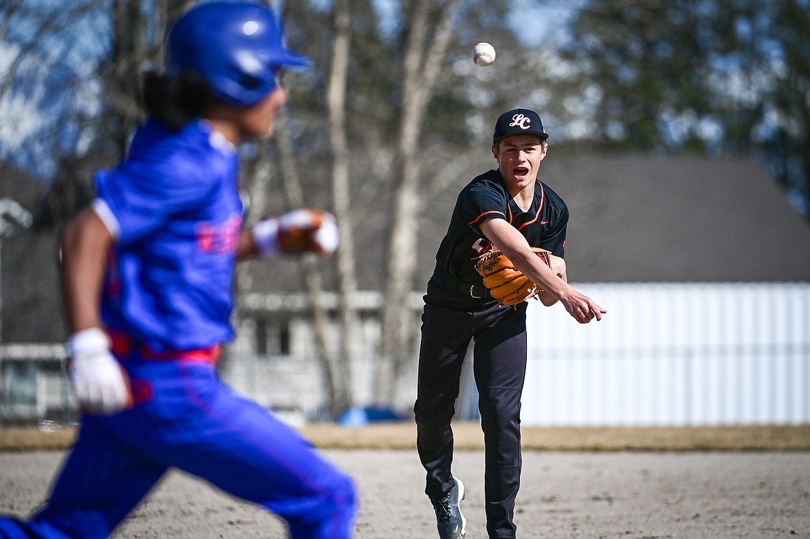 Eureka second baseman Colin Hickman (11) throws to first against Bigfork at ABS Park in Evergreen on Tuesday, April 2. (Casey Kreider/Daily Inter Lake)