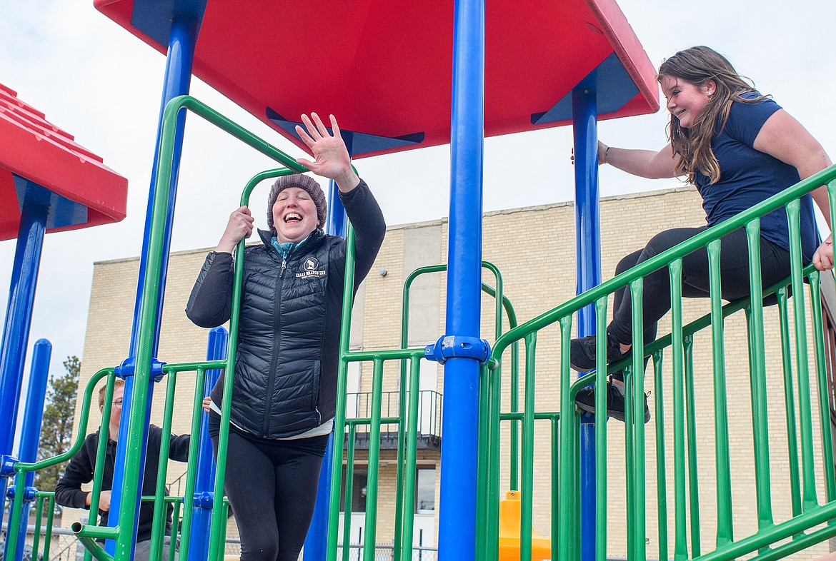 Boys and Girls Club instructor Katie VonLindern plays "Groundsie" a tag game, with a couple of kids last week at the former school at 4th Avenue West. The Club will be renting the upstairs and part of a gym for $1 a year. (Chris Peterson photo)