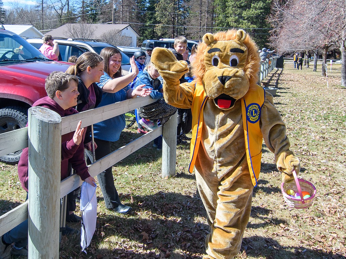 Leo the Lion high-fives the crowd before the event begins.