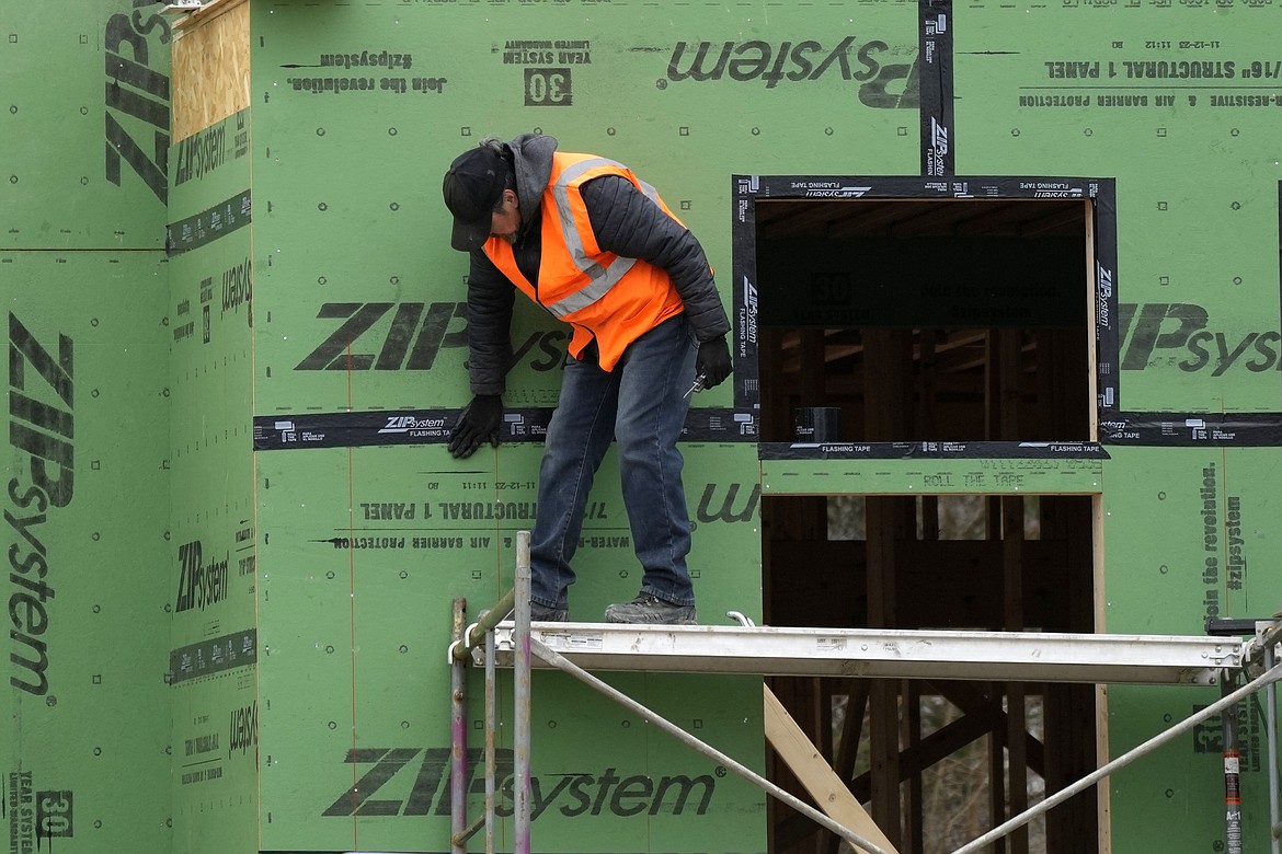 A workman secures sheathing at a residential construction site in Mount Prospect, Ill., Monday, March 18, 2024. On Tuesday, April 2, 2024, the Labor Department reports on job openings and labor turnover for February. (AP Photo/Nam Y. Huh)