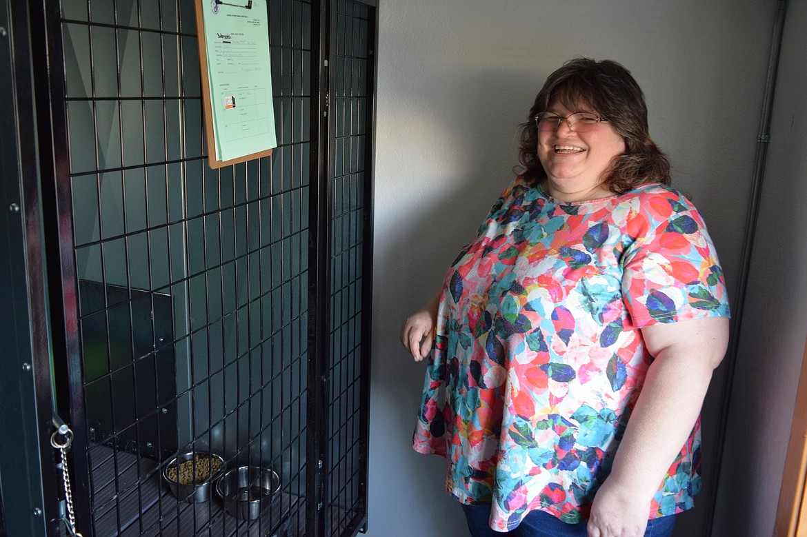Hands ‘N Paws founder Carmon Derting stands next to one of the organization’s large kennels inside its temporary Othello shelter on North Broadway Avenue. Derting said the shelter has 15 kennels of various sizes both inside and outside the building.
