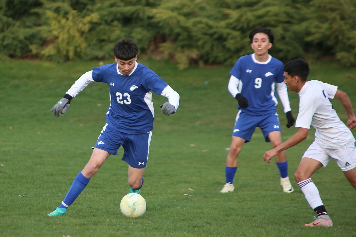 Warden senior Adrian Madrigal (23) tries to get past a Connell defender March 26. The Cougars take on Kiona-Benton Tuesday.