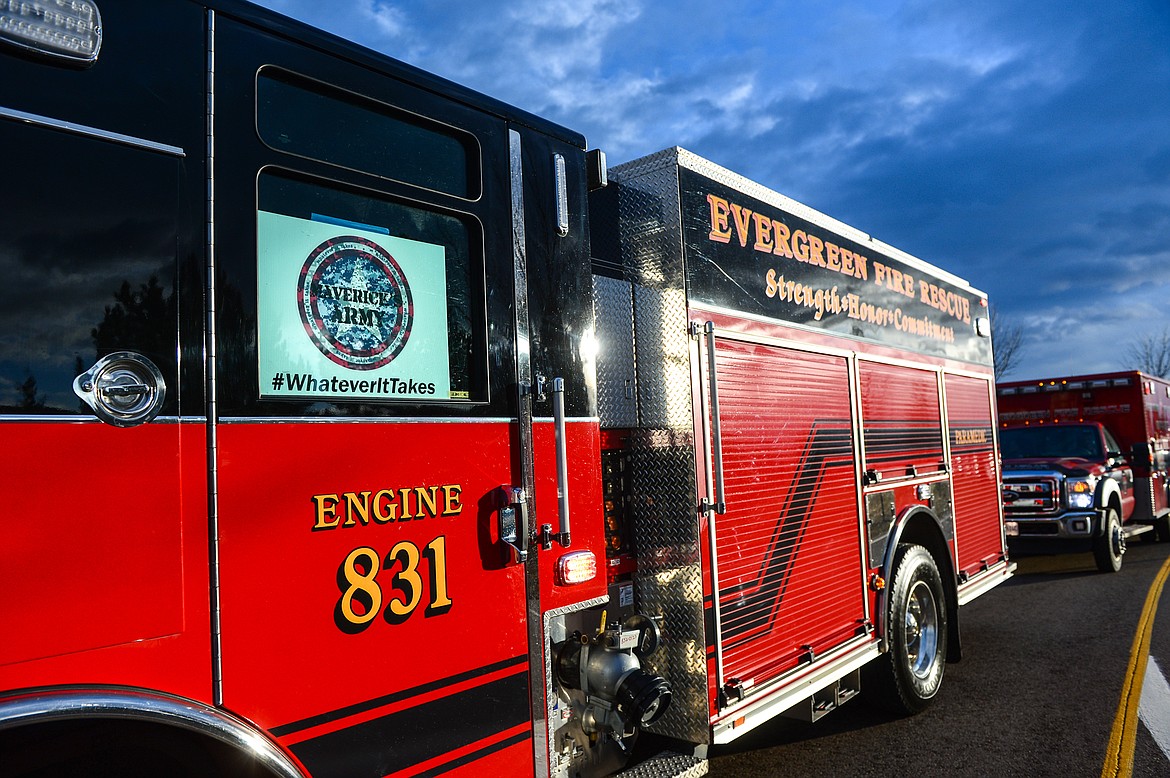 A sign for Maverick's Army is displayed in the window of  Evergreen Fire Rescue Engine No. 831 as emergency vehicles line up at Glacier Park International Airport before a procession in remembrance of 8-year-old Kila resident Maverick Bench on Wednesday. (Casey Kreider/Daily Inter Lake)